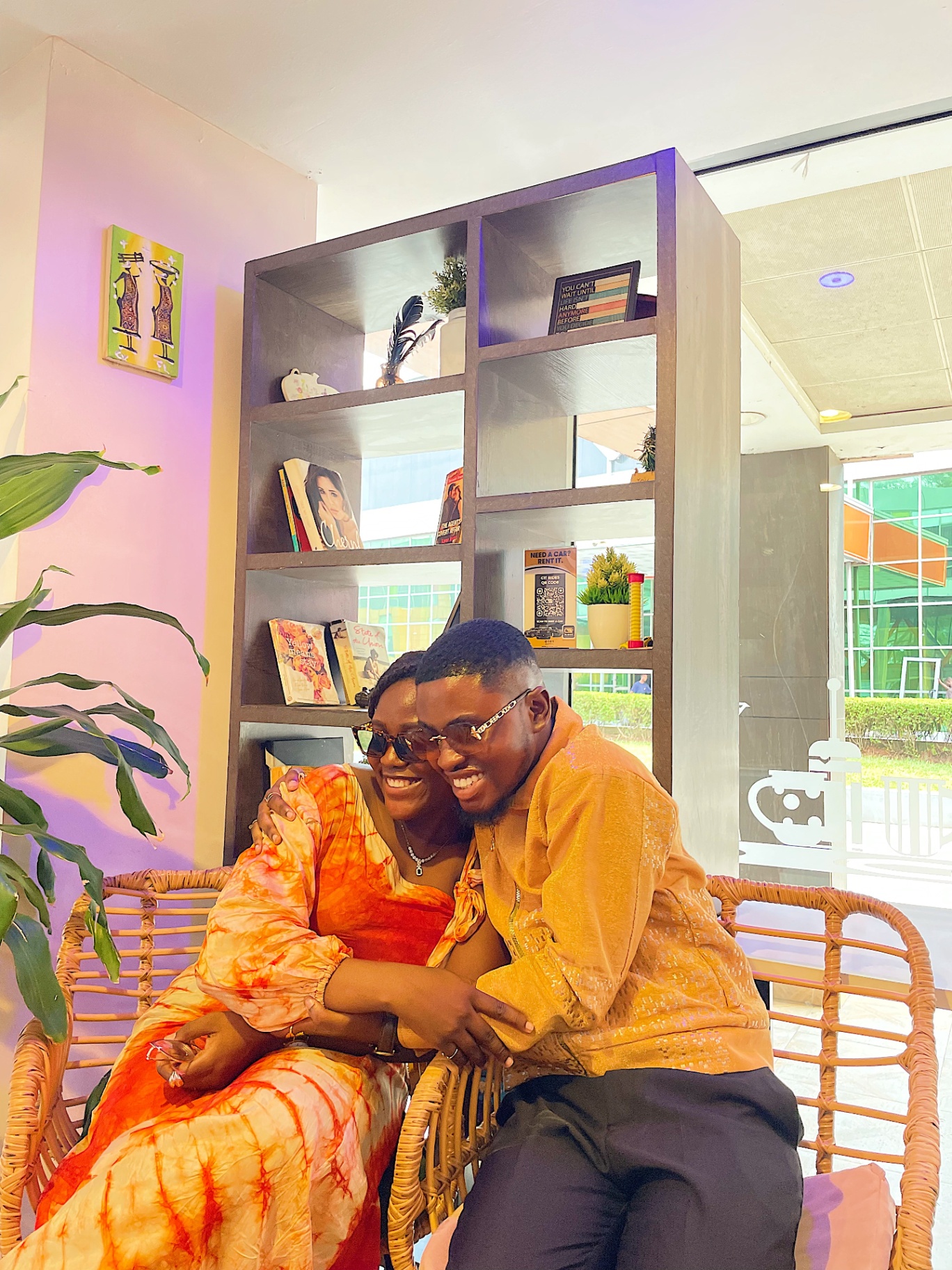 Members sharing a warm hug on rattan chairs