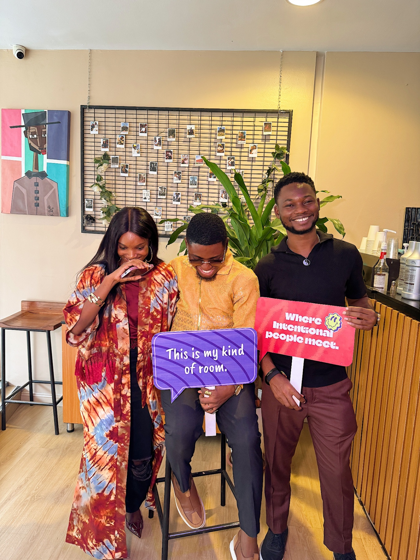 Three members posing with speech bubble signs